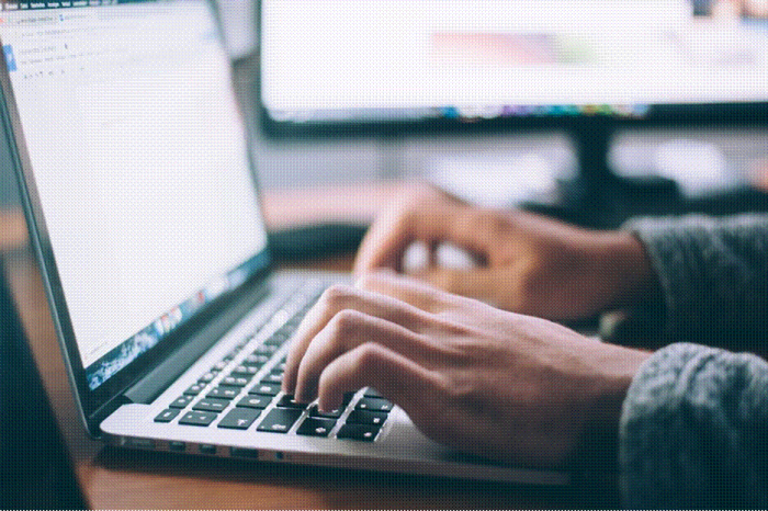 Title: Close-up of hands typing a post on a laptop keyboard - Description: Close-up of hands typing a post on a laptop keyboard
