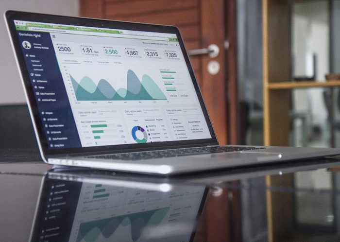Title: Laptop on a desk displaying an analytics dashboard with charts - Description: Laptop on a desk displaying an analytics dashboard with charts