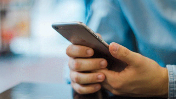 Title: Close-up of a person's hands holding and scrolling a smartphone - Description: Close-up of a person's hands holding and scrolling a smartphone